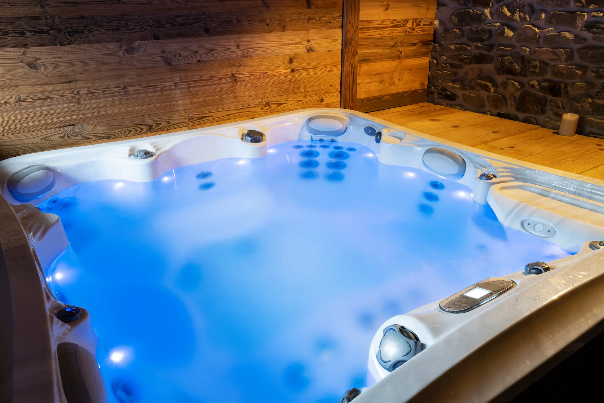 Indoor hot tub with blue lights glowing in the water